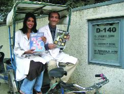 Dr. Girish Soni (specialist in Prosthodontics and Restorative Dentistry) and Dr. Sandra Soni (specialist in Oral Surgery) proudly display copies of Oral Health just outside their practice in Defence Colony, New Delhi, India. They just love the graphic photos!