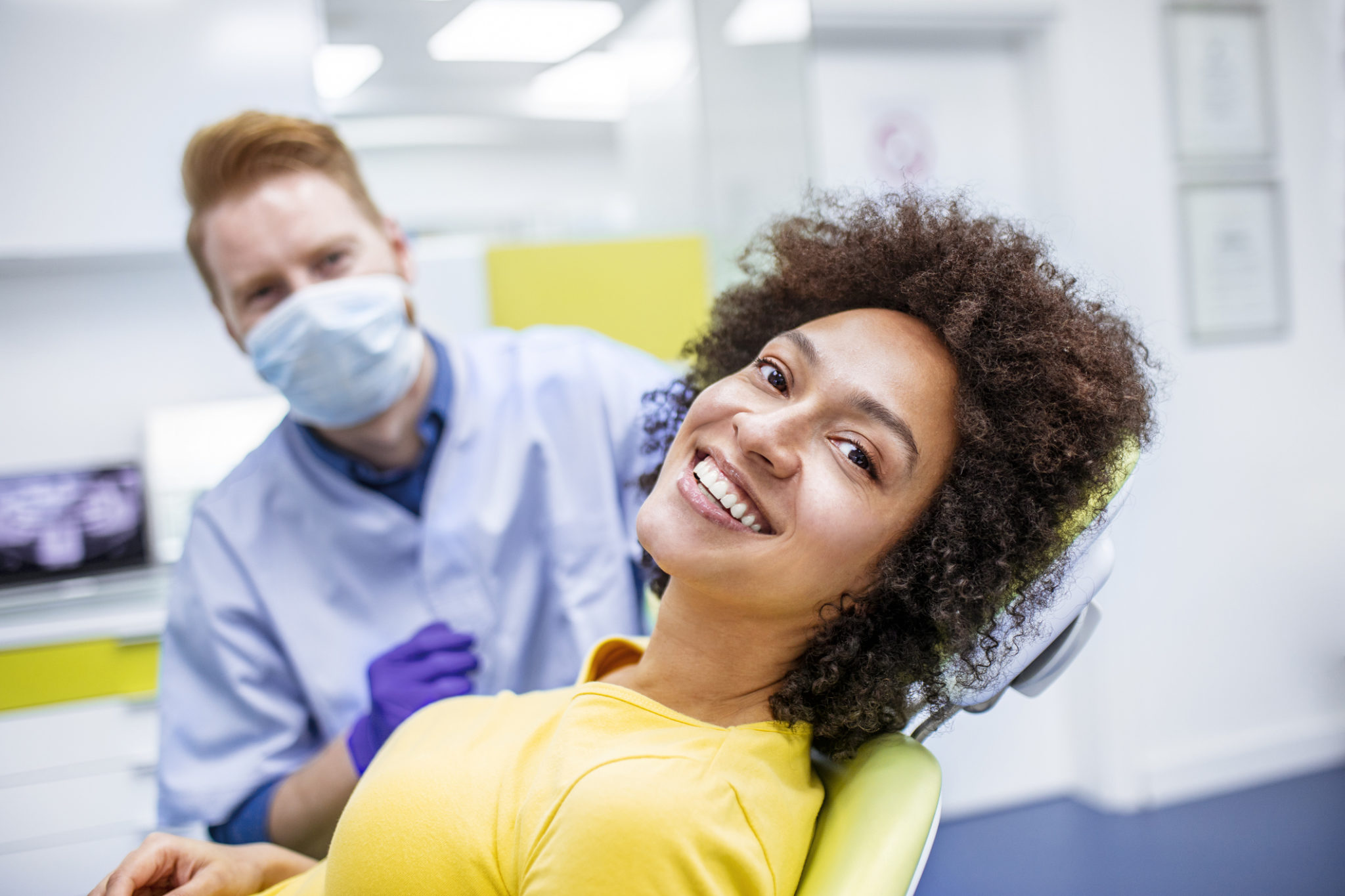 Woman smiling during dental checkup alternate text for this image