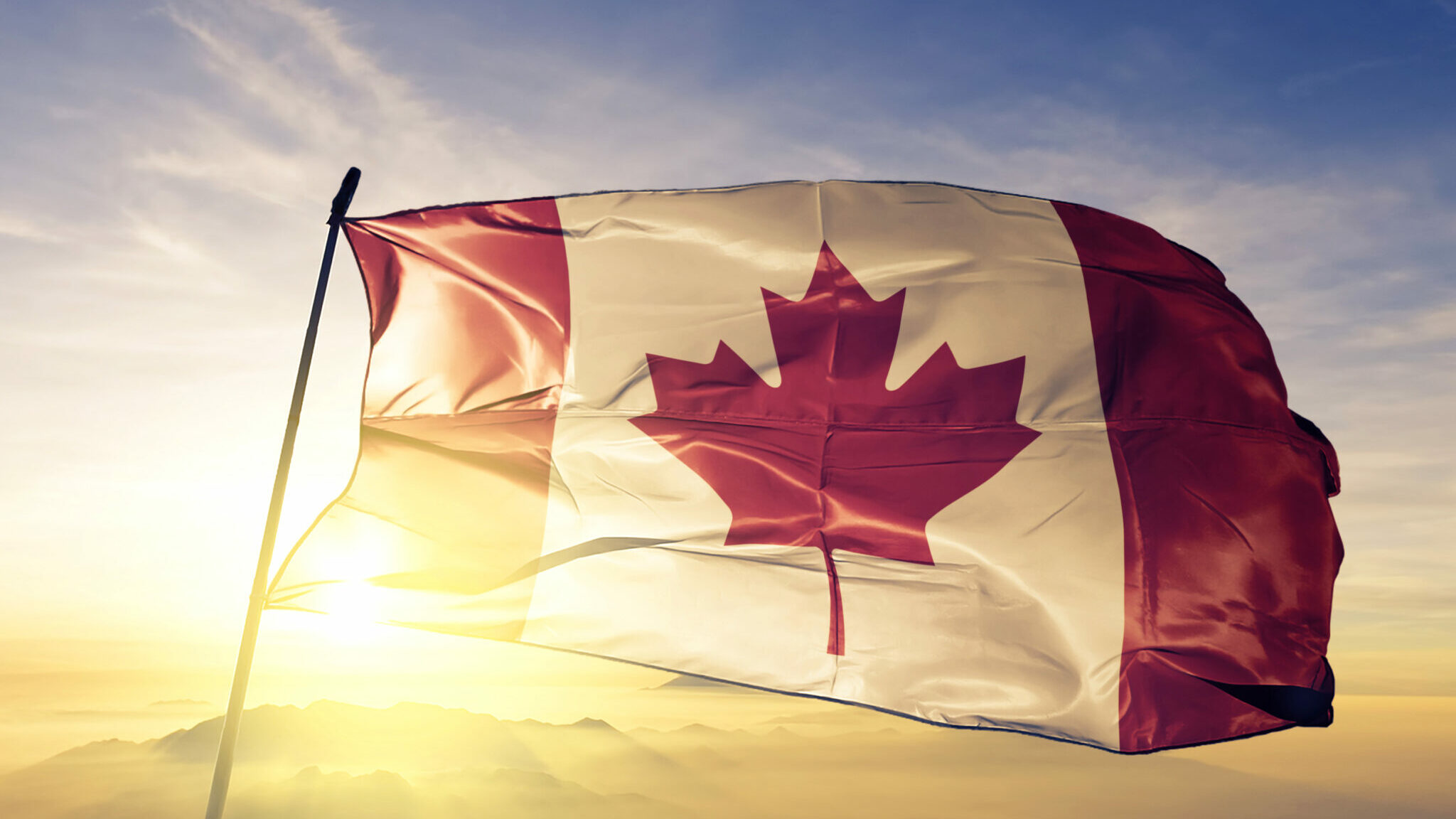 Canada Canadian flag textile cloth fabric waving on the top sunrise mist fog alternate text for this image
