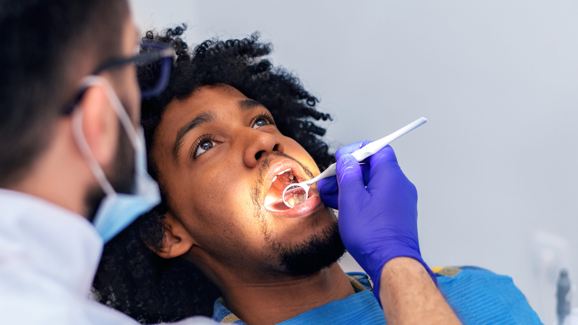 Patient Being Examined By Dentist alternate text for this image
