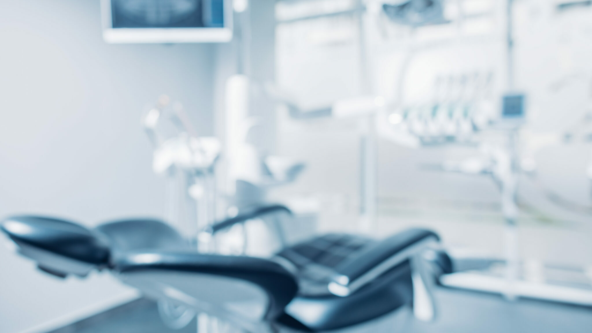 Defocused background and copy space image of dental office with dentist chair and equipment alternate text for this image