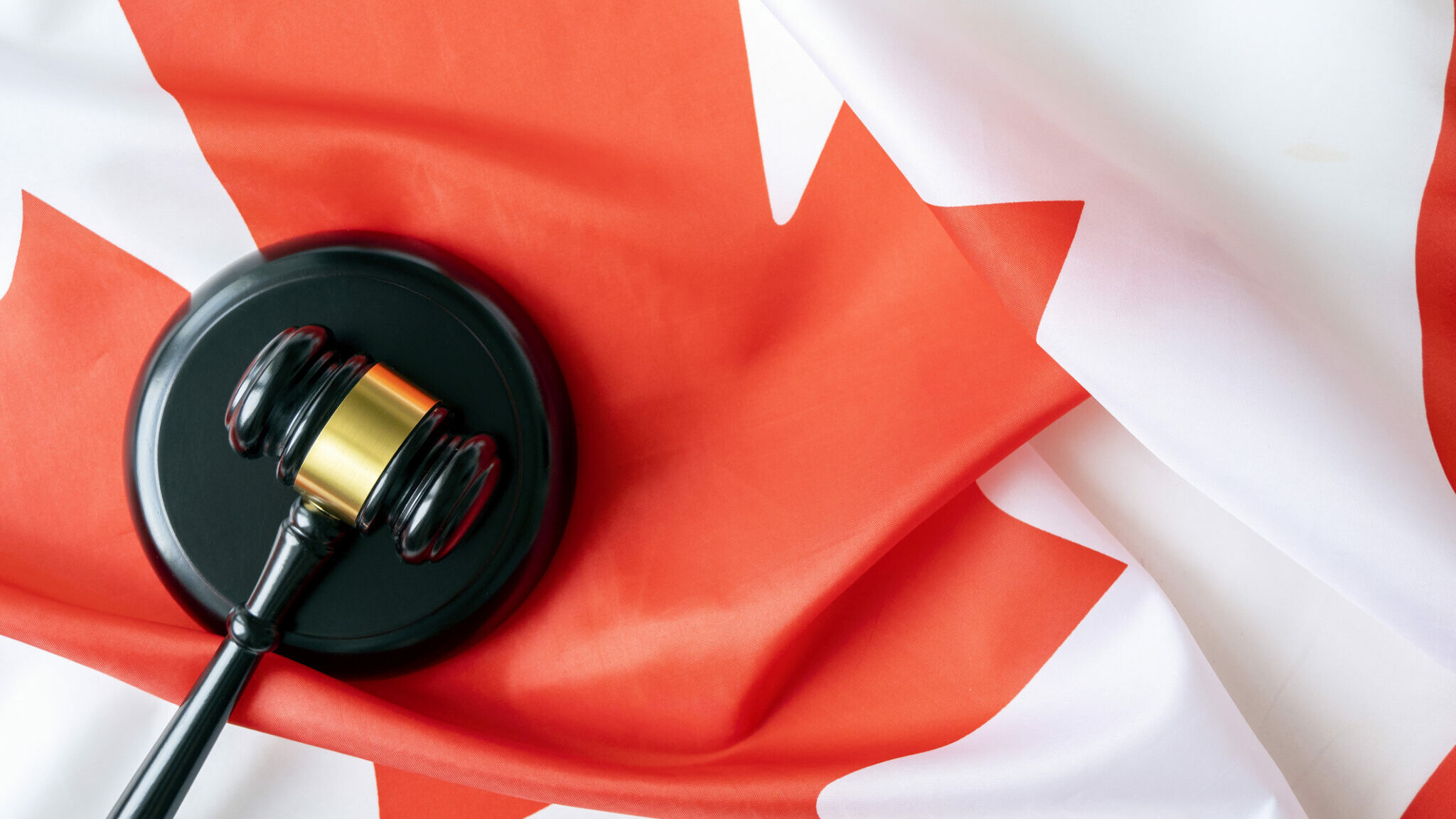 Judicial gavel on Flag of Canada, concept picture alternate text for this image