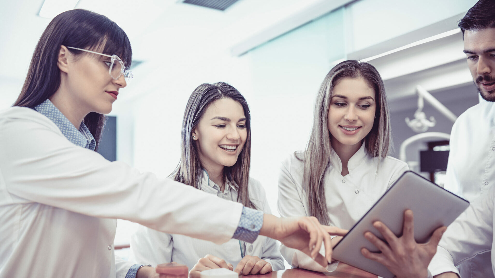 Young Medical Team Have Small Meeting at Clinics Reception alternate text for this image