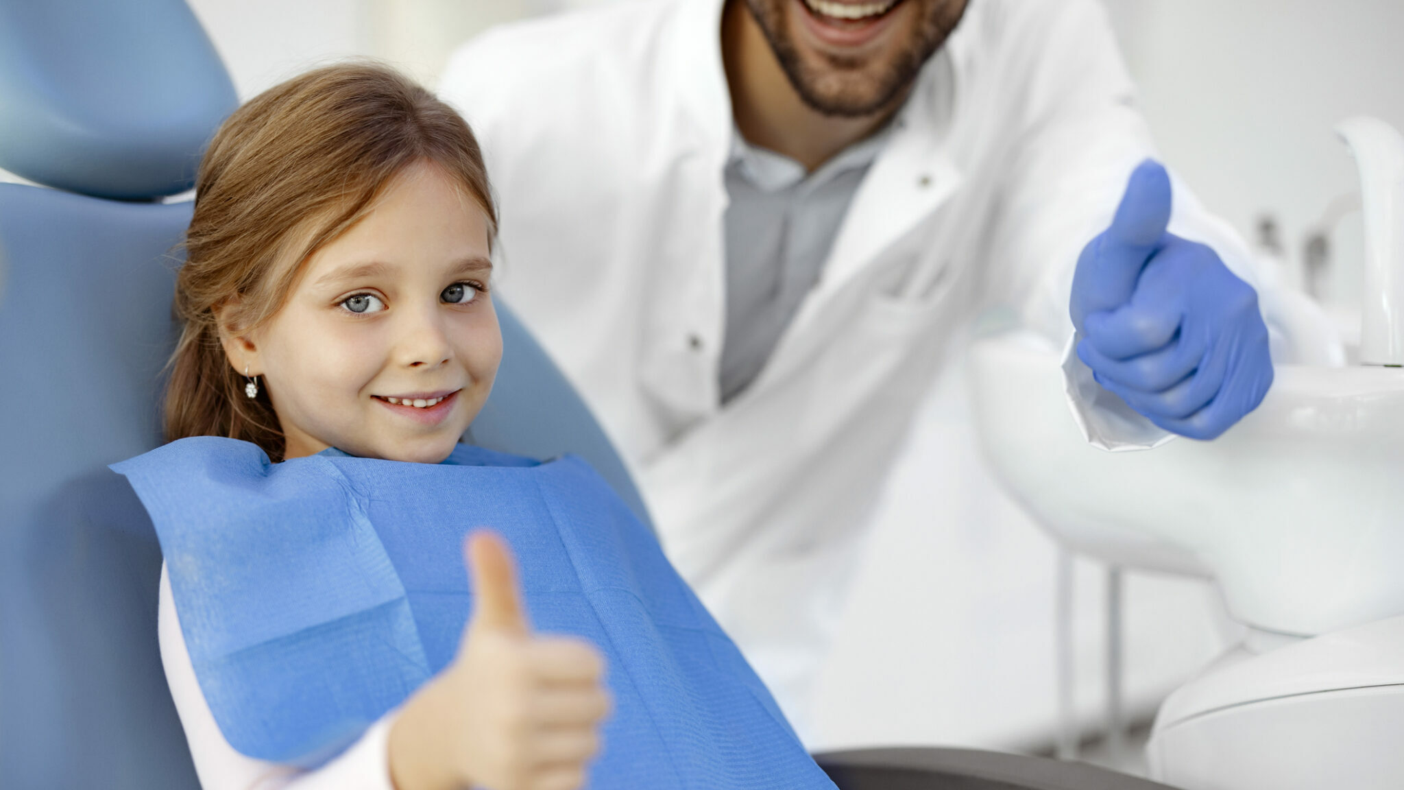 Child with Dentist Shows Thumb Up alternate text for this image