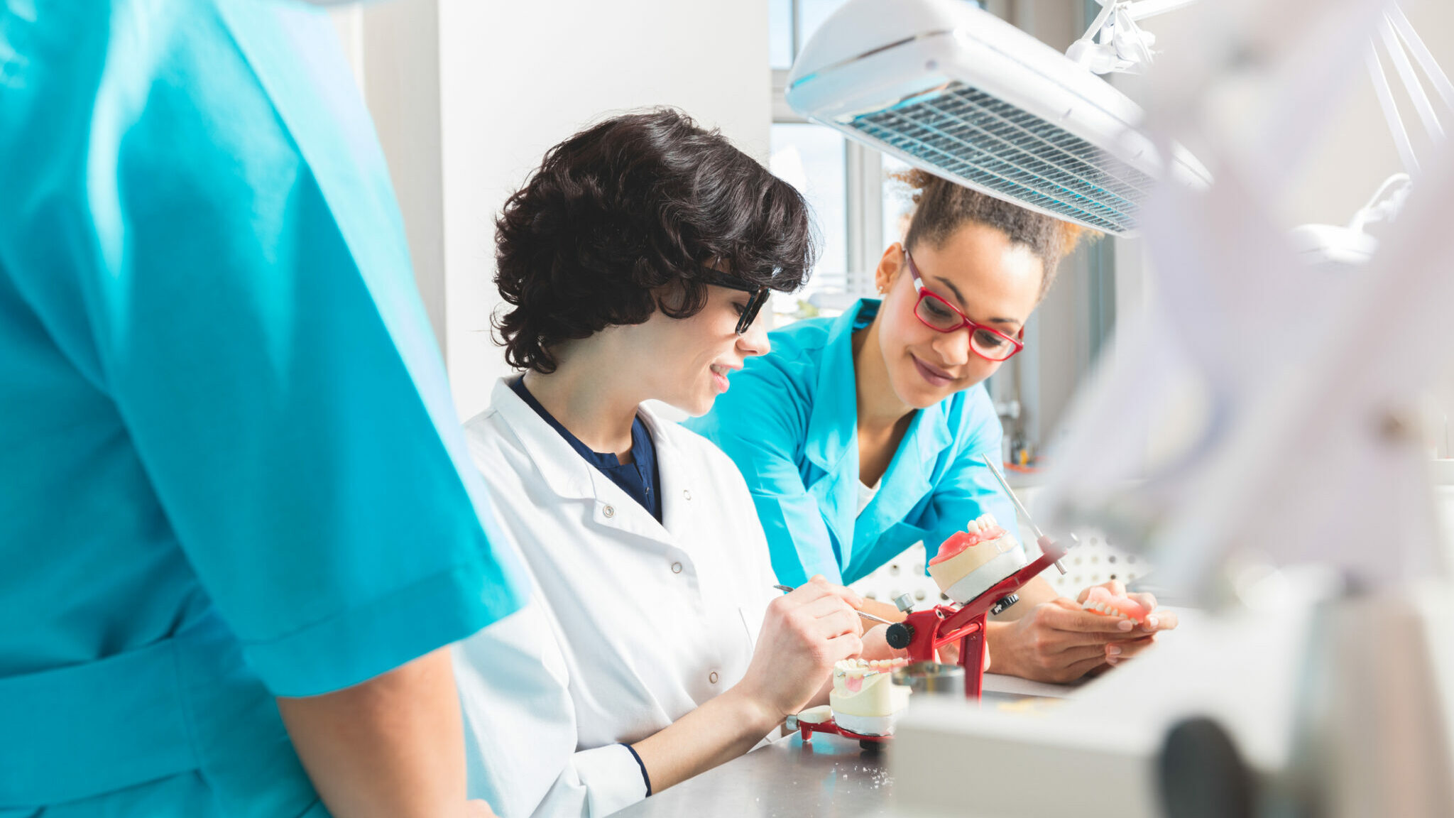Multi ethnic female students learning prosthetic dentistry alternate text for this image