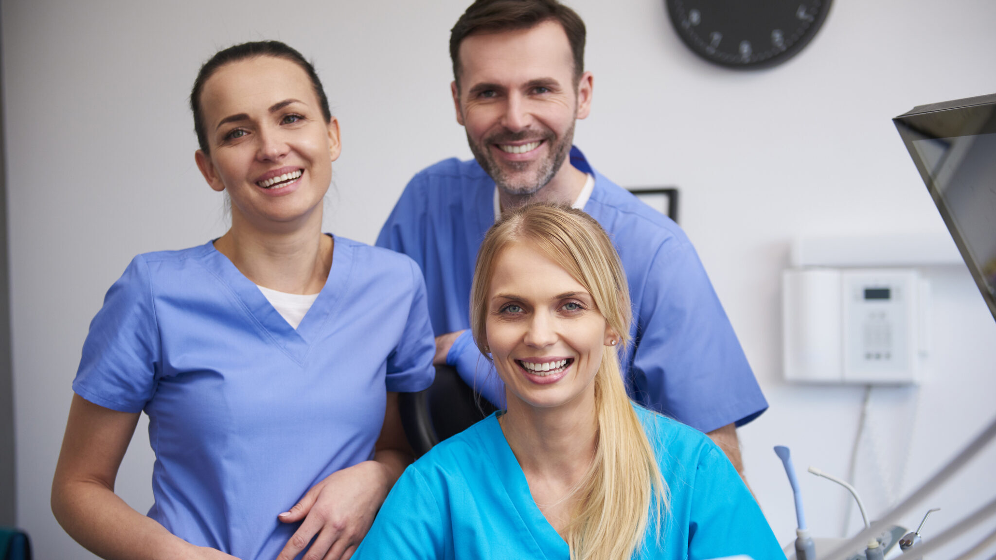 Team of happy stomatologists in dentist’s clinic alternate text for this image