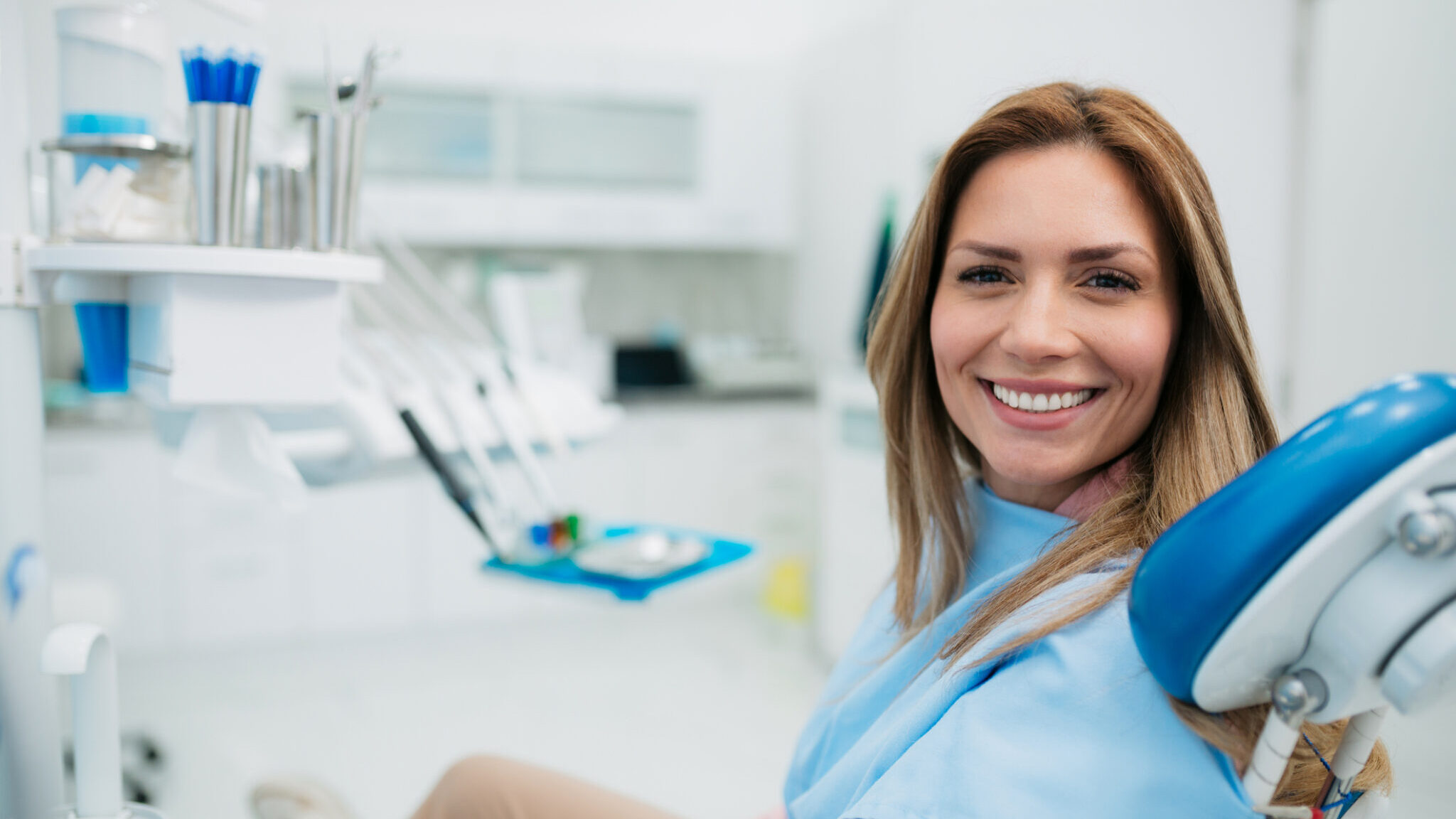 Happy woman visiting a dentist office alternate text for this image