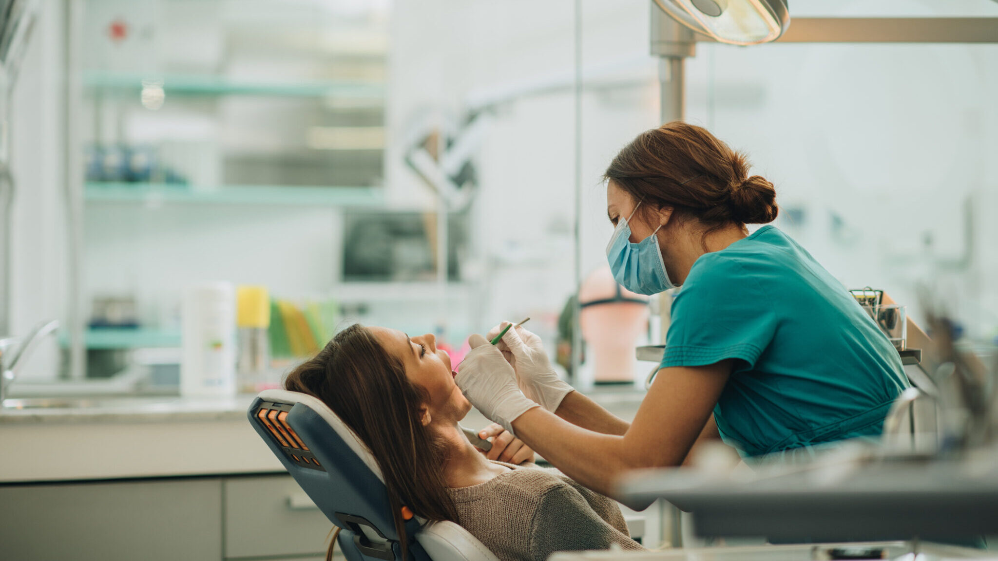 Young woman having her teeth checked during appointment at dentist’s office. alternate text for this image