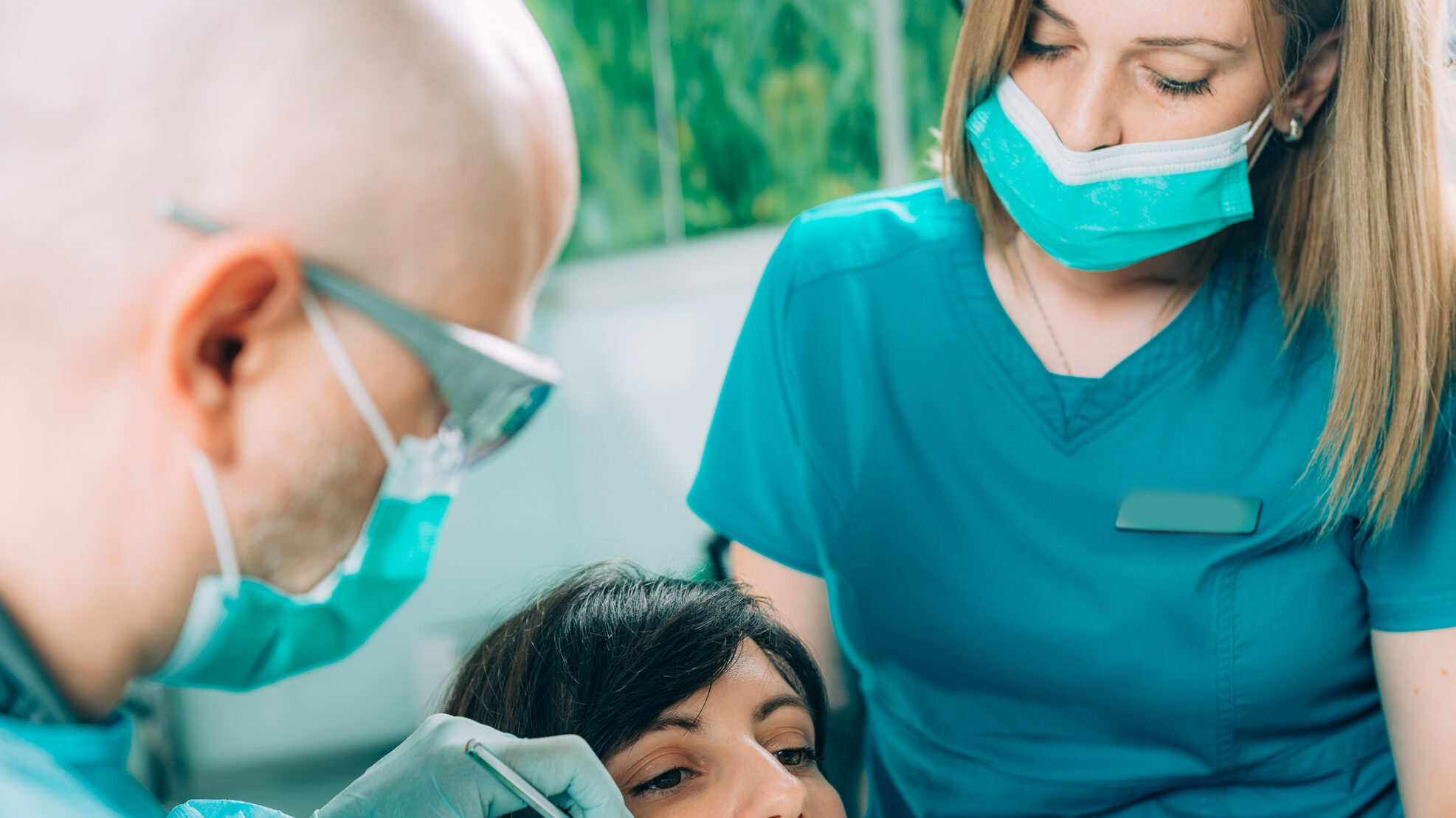 Dentist Working with Young Female Patient alternate text for this image