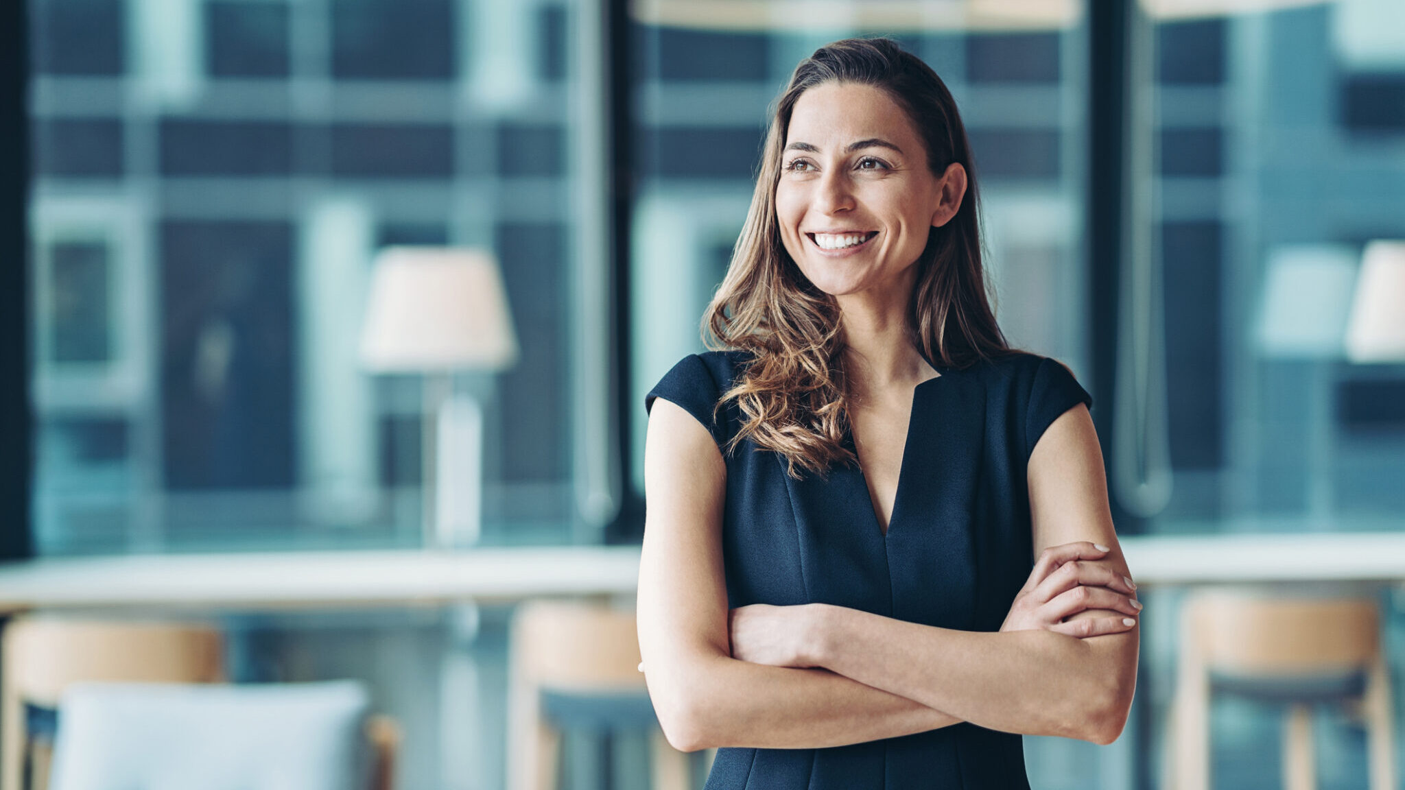 Portrait of a businesswoman standing in a a modern office alternate text for this image