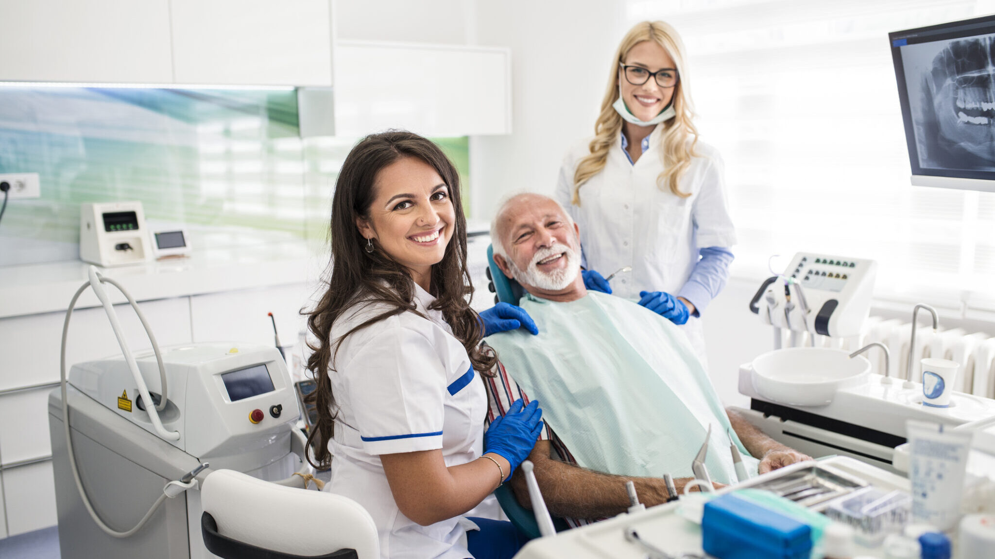 Senior man at the dentist receiving treatment alternate text for this image