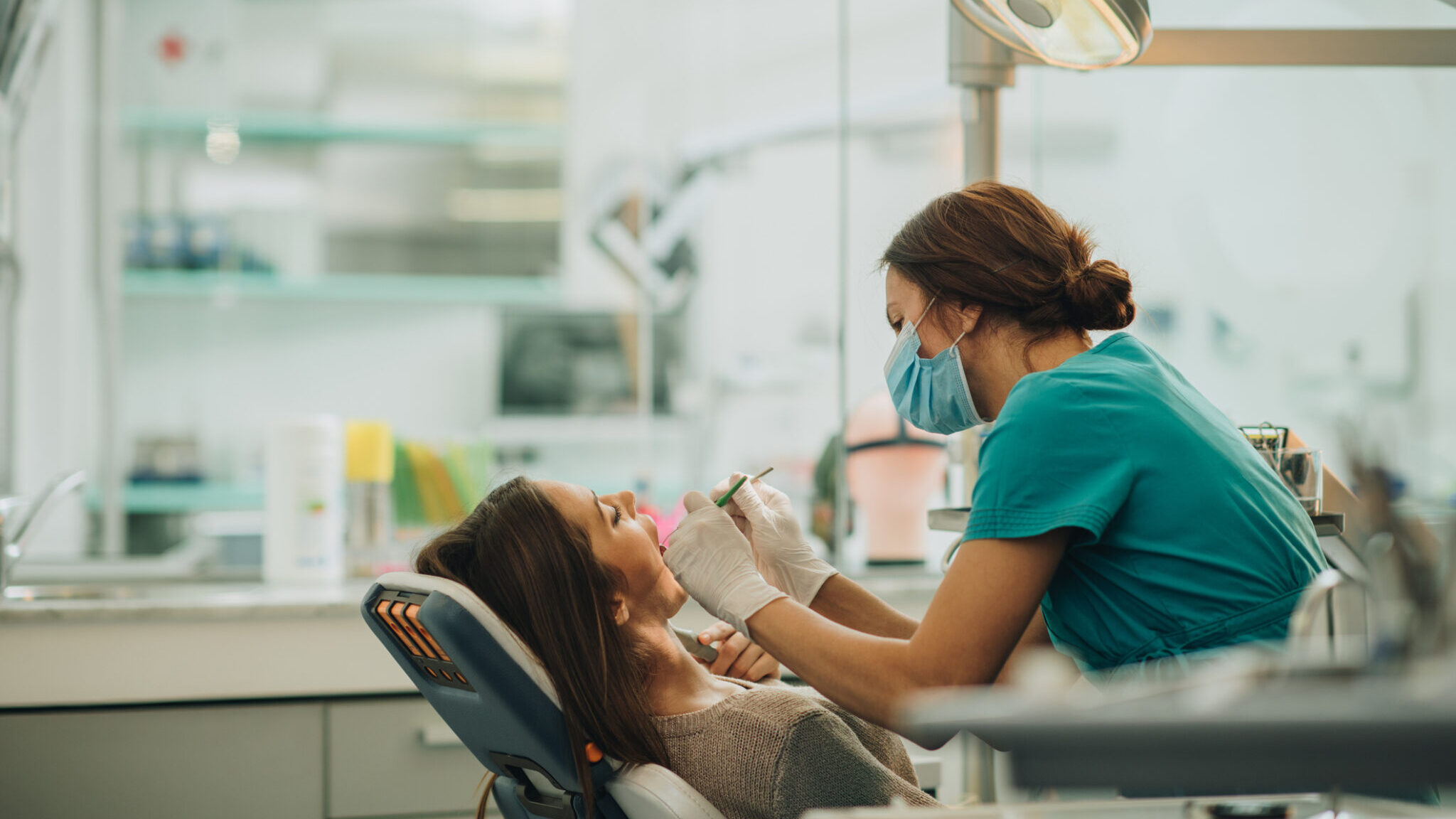 Young woman having her teeth checked during appointment at dentist’s office. alternate text for this image