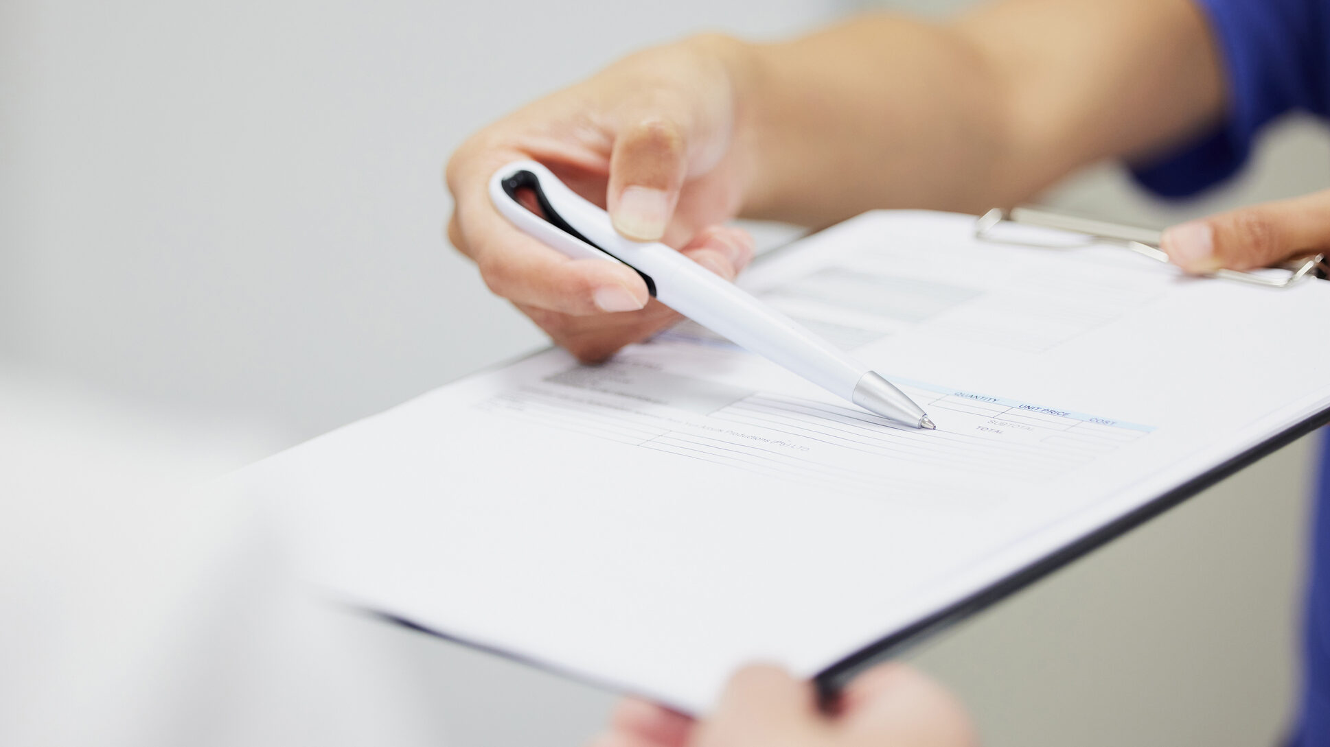 Shot of two unrecognizable people discussing a contract in a office alternate text for this image