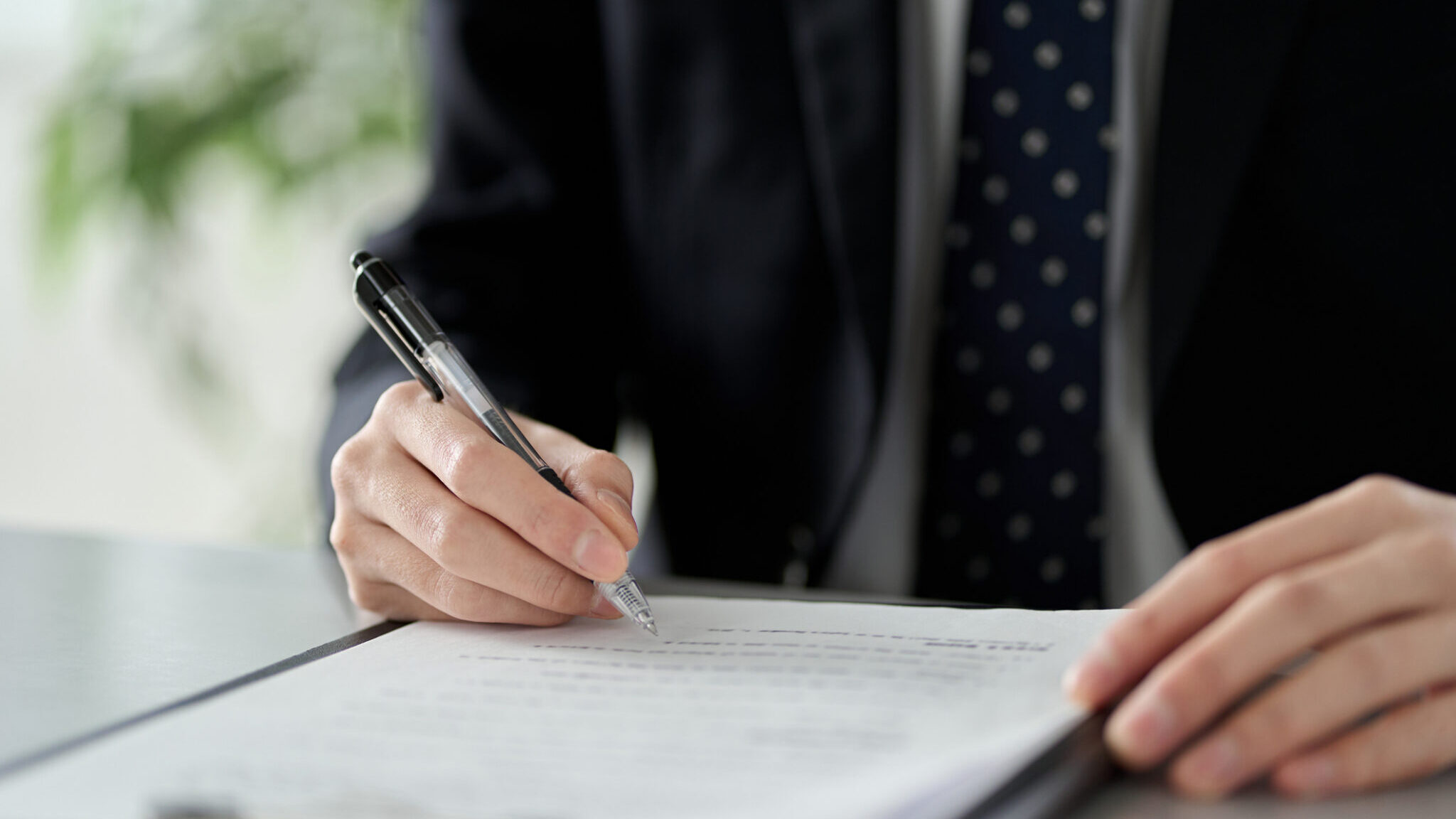 Asian businessman checking the content of documents alternate text for this image