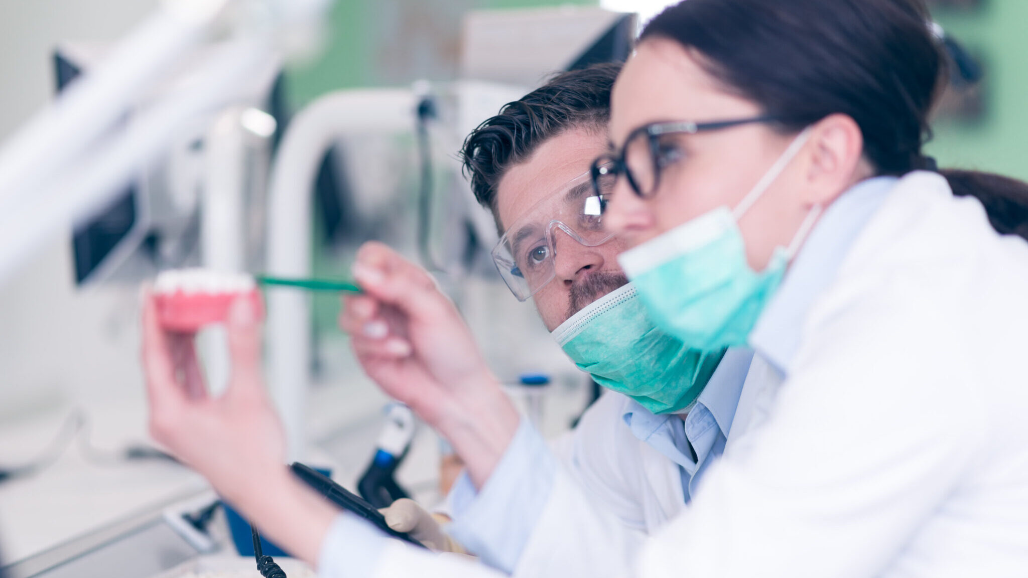 Busy young stomatology students working carefully on anatomical models alternate text for this image