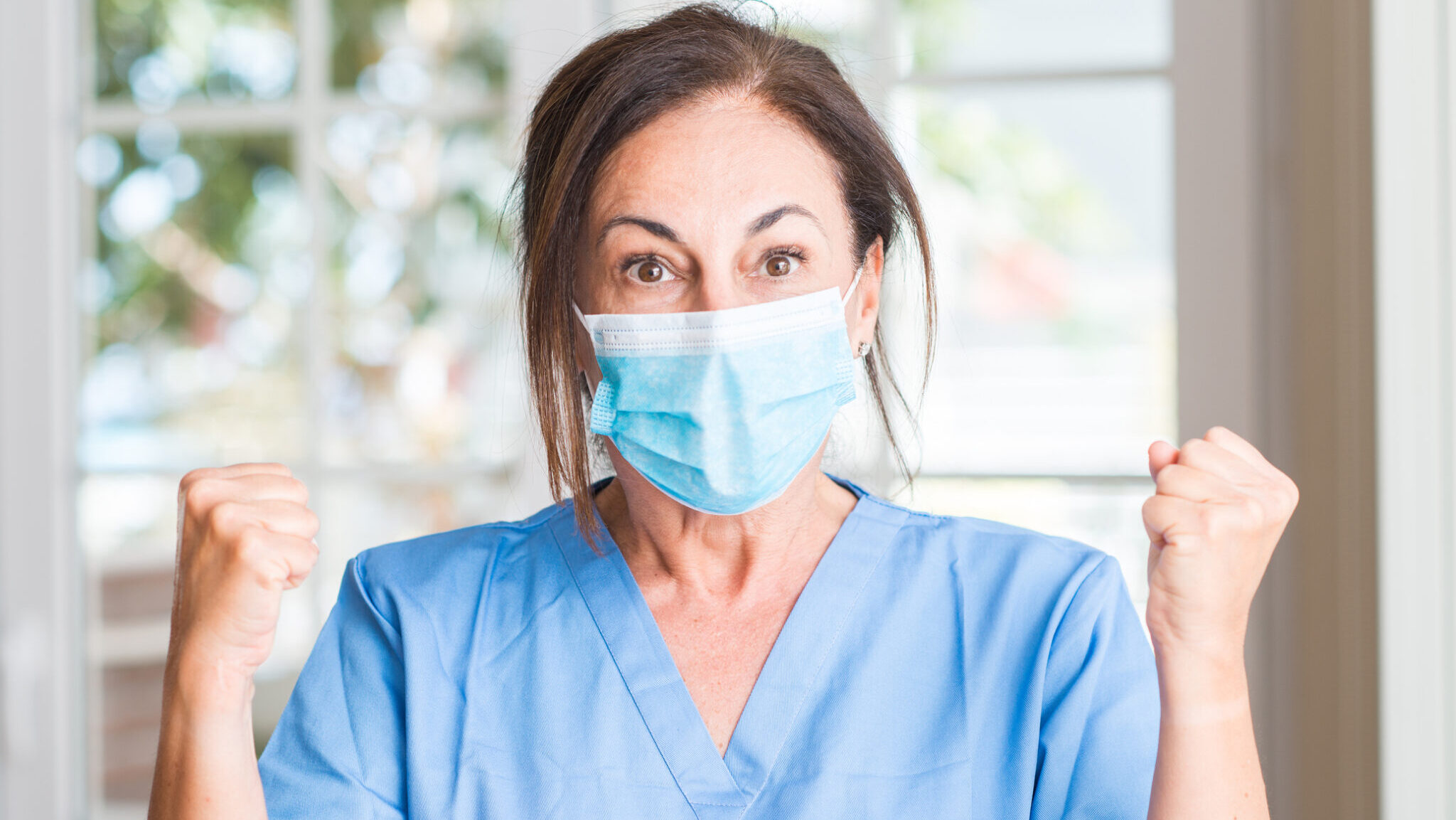 Middle aged doctor woman screaming proud and celebrating victory and success very excited, cheering emotion alternate text for this image