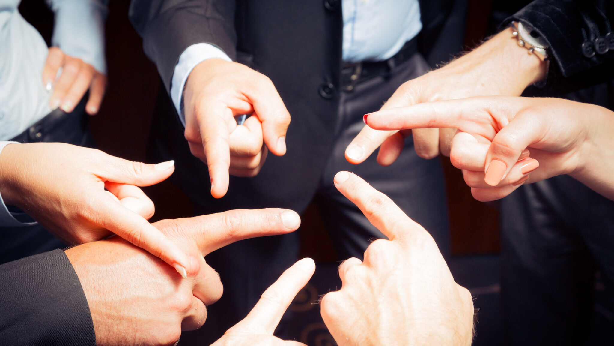 business team blaming each other alternate text for this image