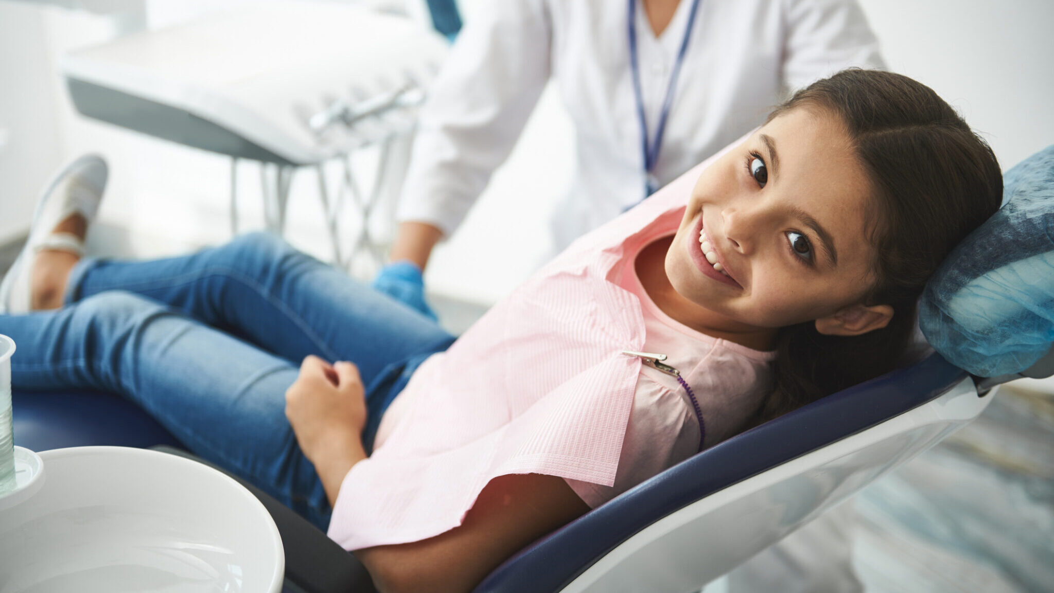 Overjoyed nice girl visiting her professional dentist alternate text for this image