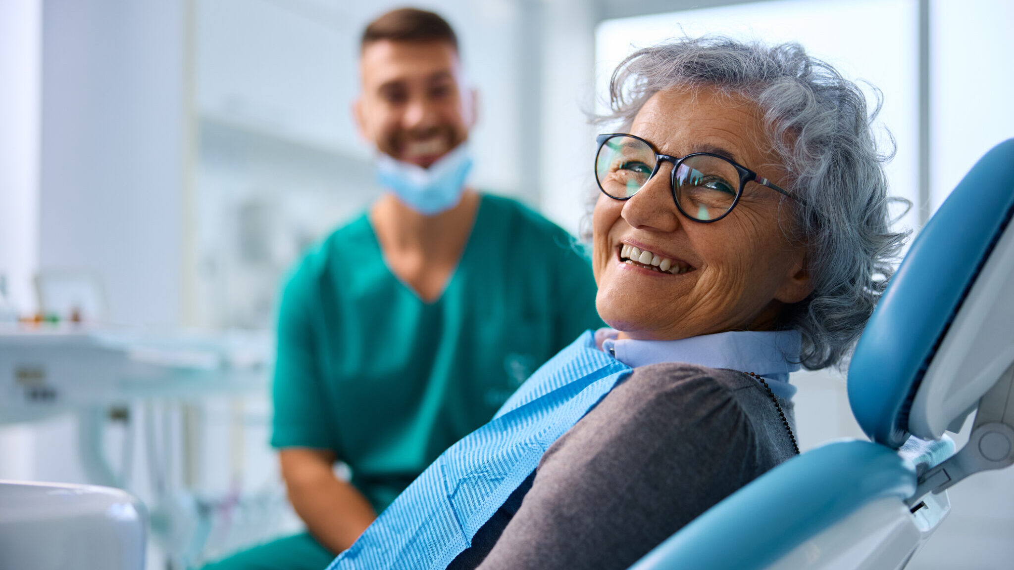 Satisfied senior woman at dentist’s office looking at camera. alternate text for this image
