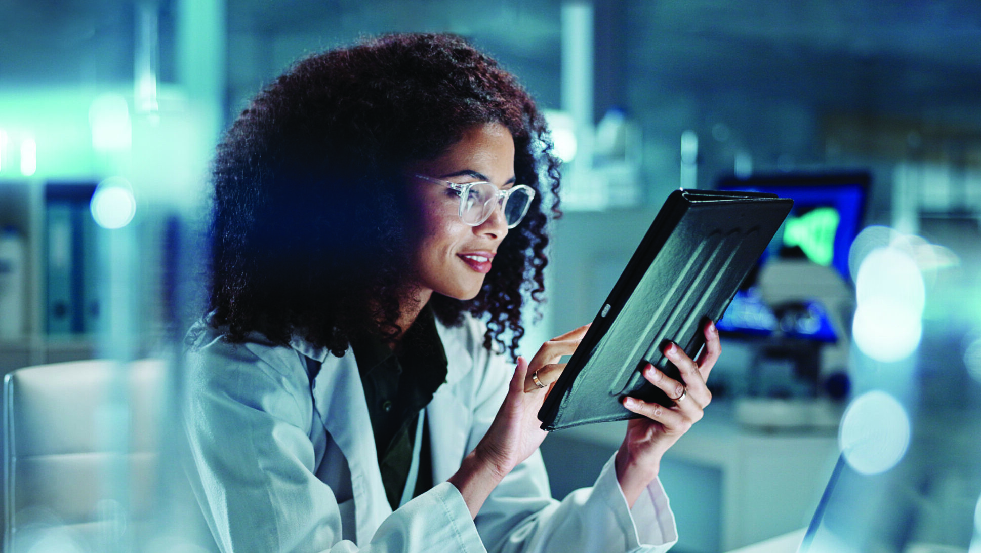Tablet, laptop and woman scientist in lab working on medical research, project or experiment. Science, career and female researcher with digital technology and computer for pharmaceutical innovation. alternate text for this image