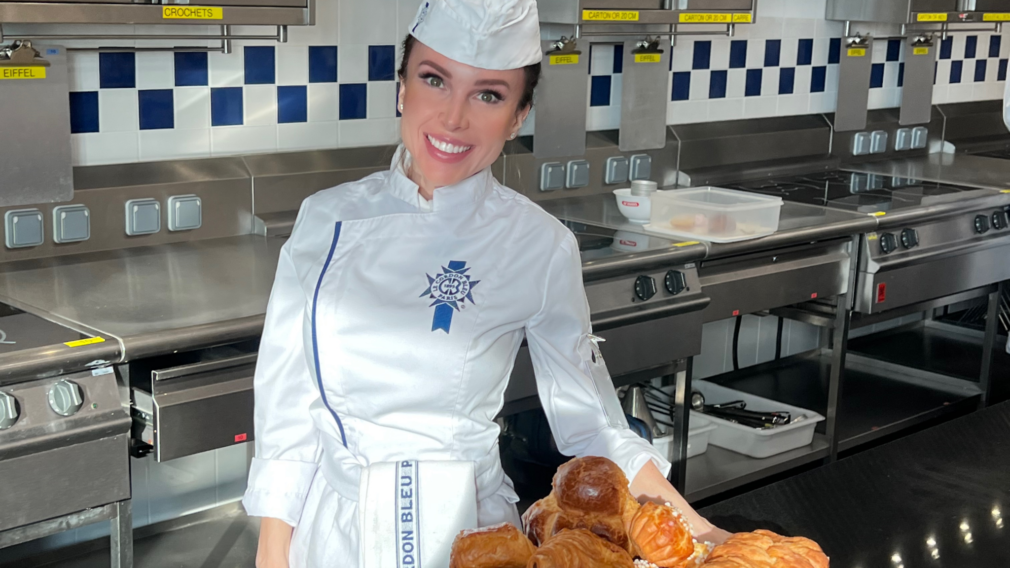 Alina Fintineanu at Le Cordon Bleu in Paris, proudly displaying one of her bakes. (Supplied photo)