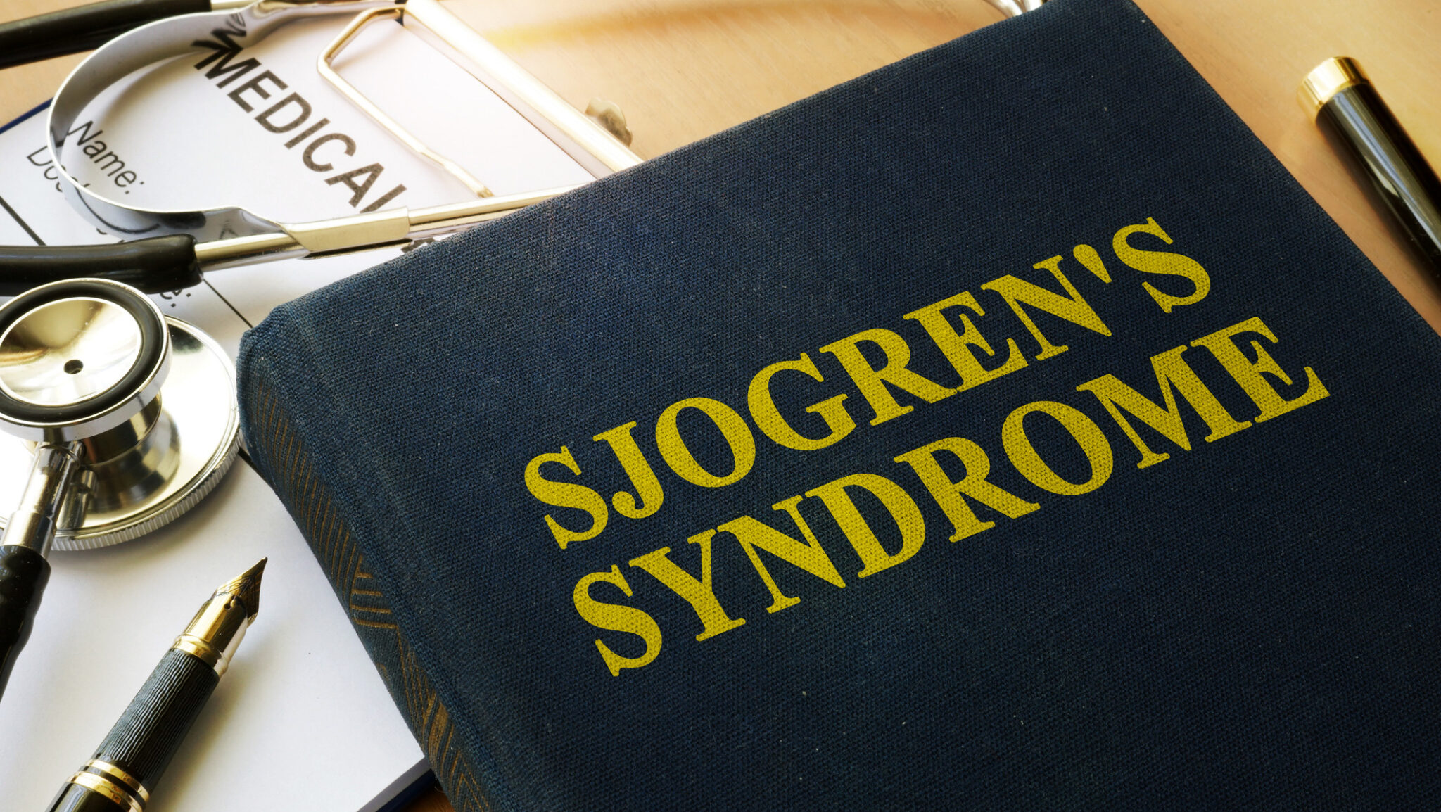 Book with title Sjogren’s Syndrome on a table. alternate text for this image